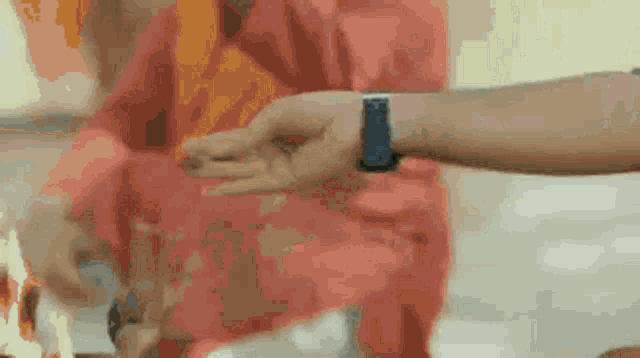 a close up of a person 's hand with a watch on their wrist .