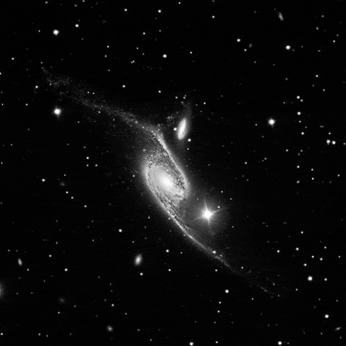 a black and white image of a galaxy in the night sky