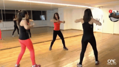 a group of women are dancing in front of a mirror with one how to written on the bottom right