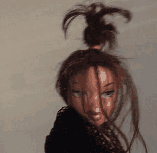 a doll with a bun in her hair is wearing a black top