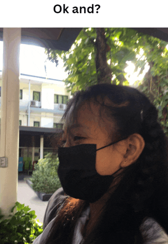 a girl wearing a black mask with the words ok and underneath