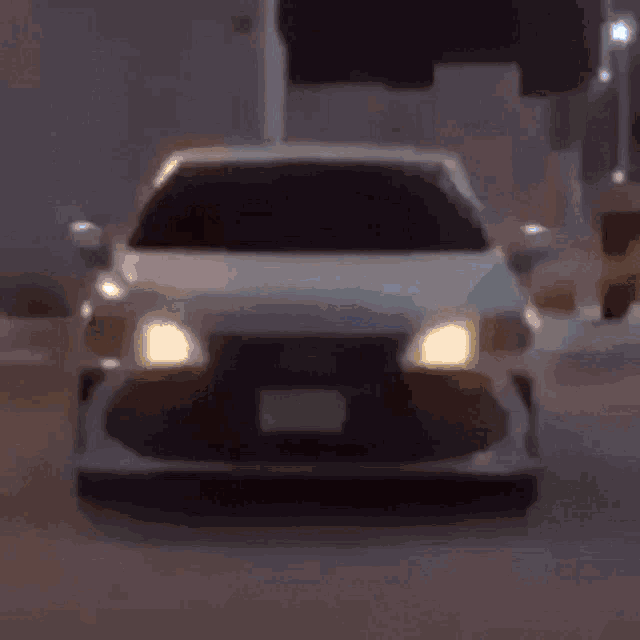 a close up of a car 's headlights glowing in the dark