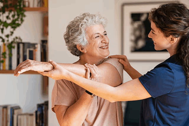 an elderly woman is being helped by a nurse