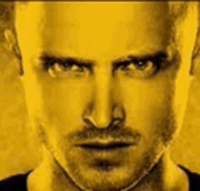 a close up of a man 's face against a yellow background .