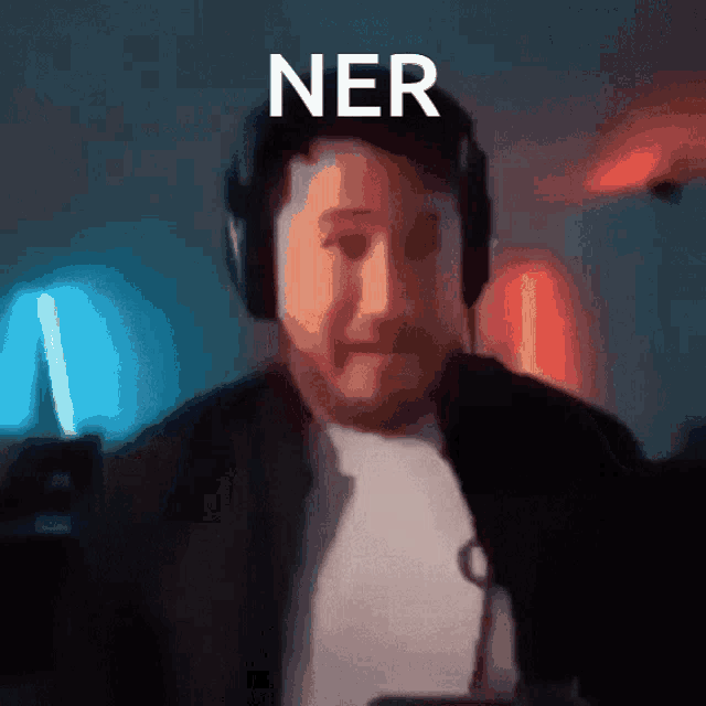 a blurry picture of a man wearing headphones and the word ner on the bottom