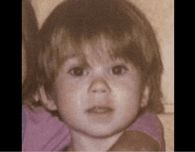 a close up of a little girl 's face in a photo .