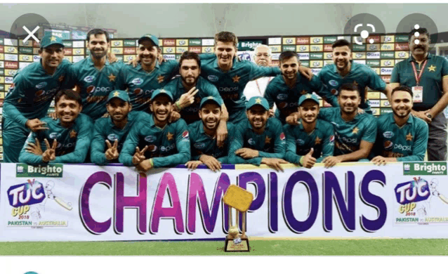 a group of cricket players pose for a photo with a banner that says champions