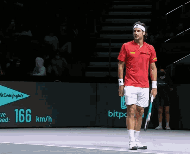 a man holding a tennis racquet on a court with a sign that says 166 km / h in the background