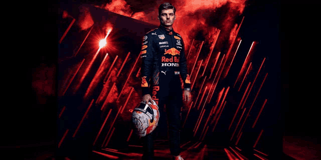 a man in a red bull uniform is holding a helmet .