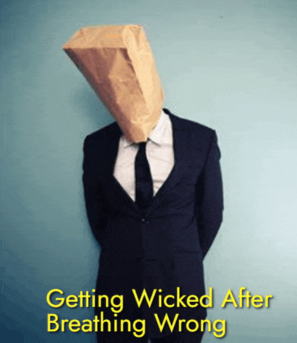 a man in a suit and tie has a paper bag over his head and the words getting wicked after breathing wrong below him