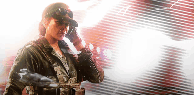 a woman in a military uniform is holding a gun and talking on a cell phone