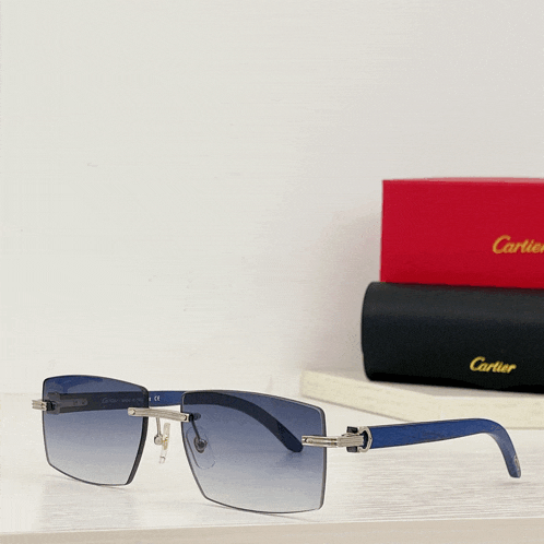 a pair of blue cartier sunglasses sits on a table