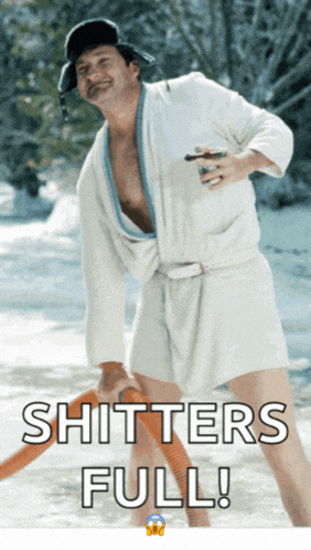 a man in a bathrobe is holding a vacuum hose with the words " shitters full " below him