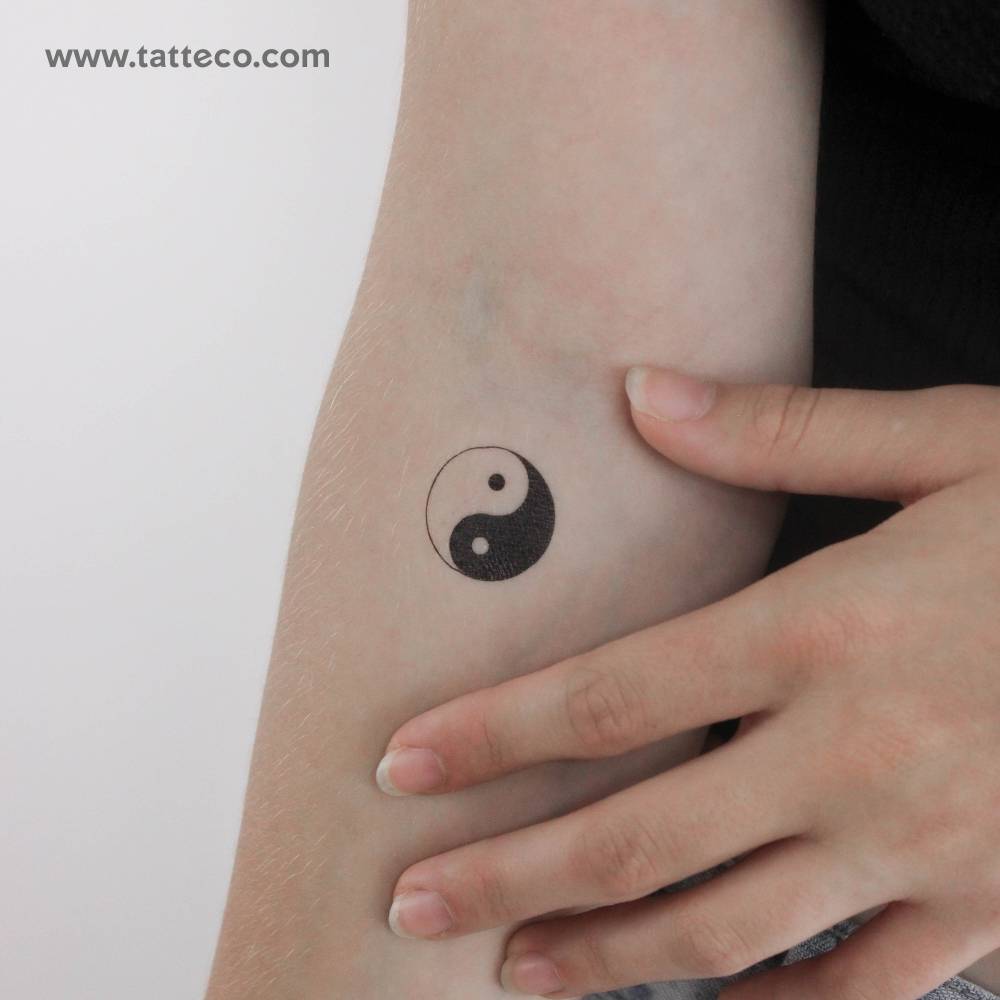 Yin yang temporary tattoo done on the inner forearm.