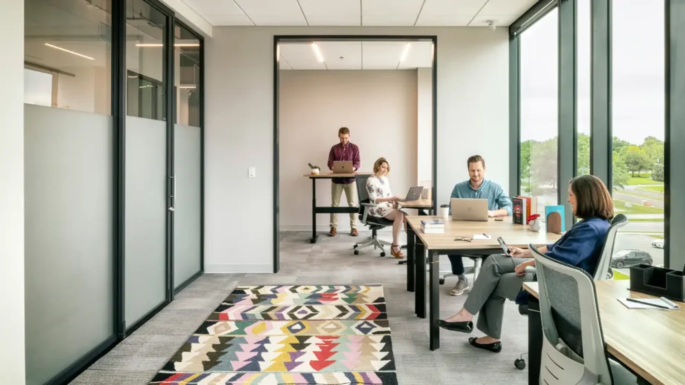 Large open Team Room with large windows facing the city.