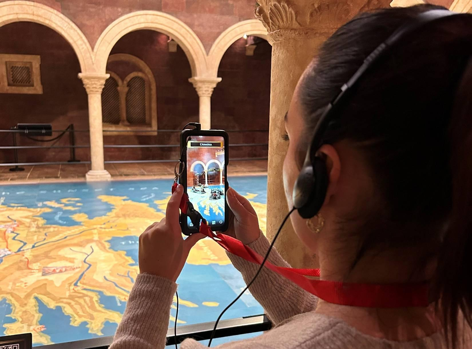 Girl using audio guide handset in kings landing