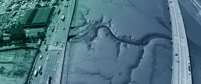 Spatial Variation of Asymmetry in Velocity and Sediment Flux Along the Artificial Aam Tidal Channel