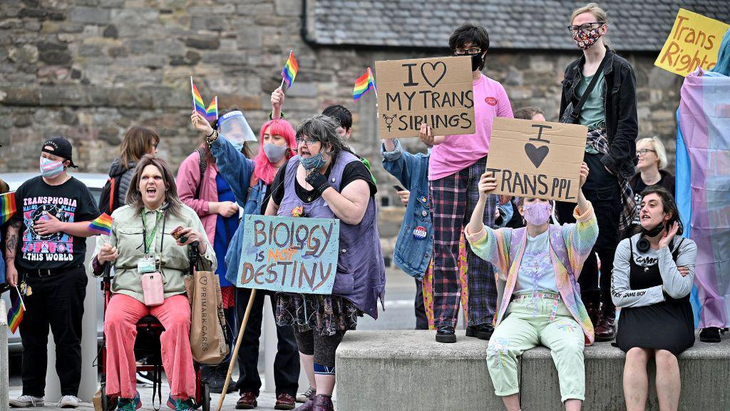 Rally of trans rights campaigners outside the Scottish Parliament> many are holding up placards.