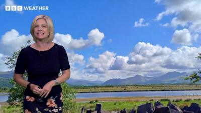 Sarah Keith-Lucas in front of a landscape photo