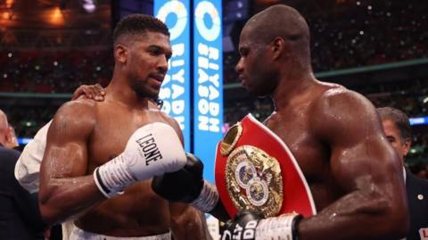 Anthony Joshua and Daniel Dubois fist bump in the ring after their fight