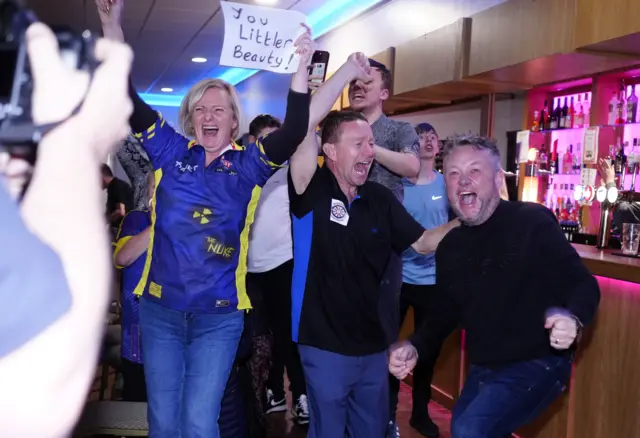 Members of Luke Littler's local darts club in St Helens celebrate a historic victory.