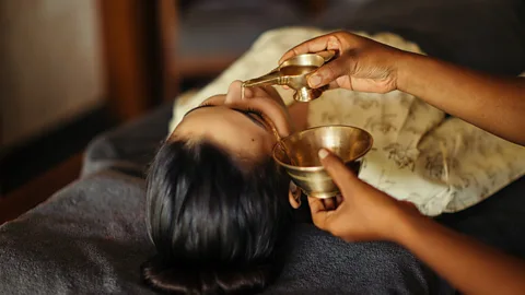 Woman having Ayurvedic oil treatment