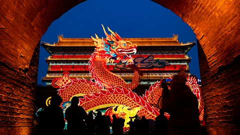 Getty Images An illuminated red-and-golden dragon at a festival in China (Credit: Getty Images)