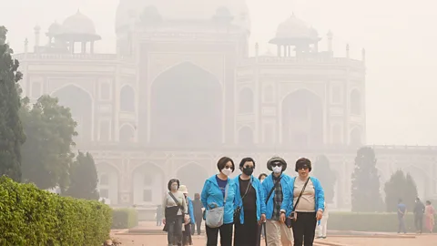 Getty Images Visitors wearing mask in smog at Humayun's Tomb, New Delhi, India (Credit: Getty Images)