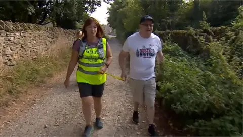 Andrew walking with aid