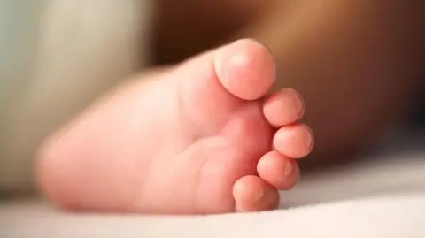 A close up photo of a baby's foot. Stock image.