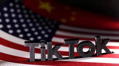 A stock image shows a 3D version of the TikTok logo stood on the flags of the US and China