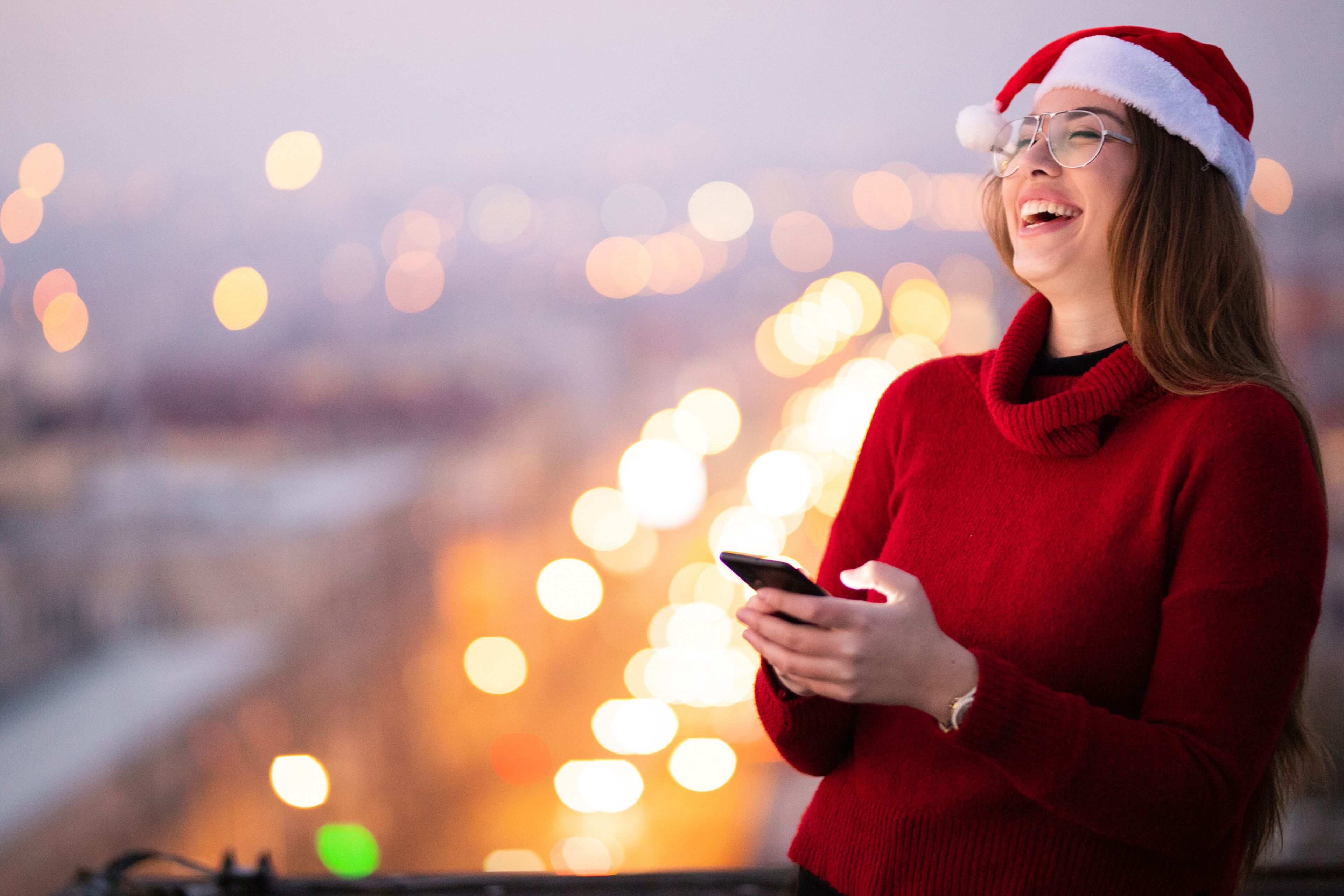 una chica mirando su móvil en Navidad