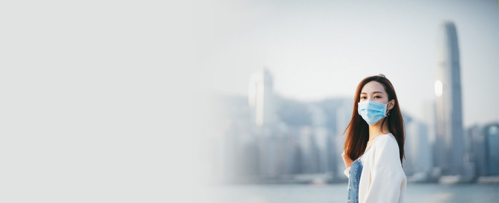 Person in mask with city behind