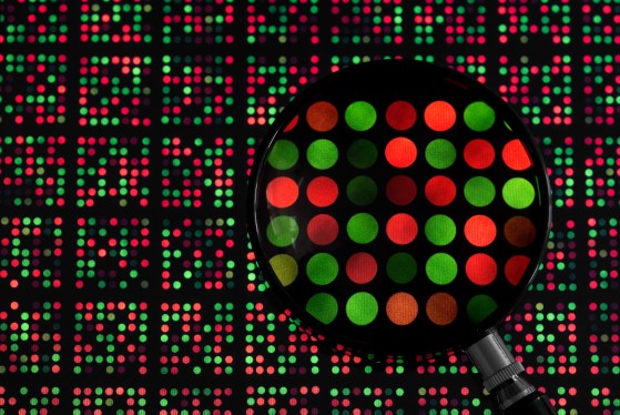 magnifying glass examining DNA chip