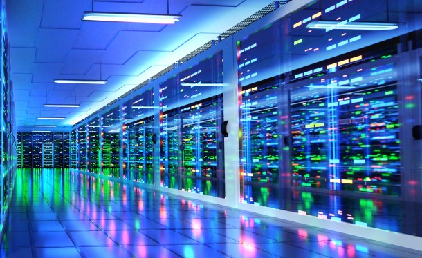 Stylized server room in data center with colored lights reflected in shiny floor.