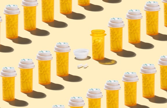 An Opened Prescription Medicine Bottle Among Many Other Sealed Bottles on Yellow Background High Angle View.