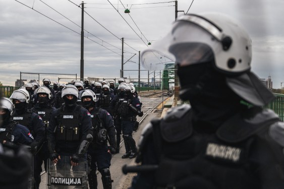 a photo of Serbian police units in riot gear guard the entrance to the Old Sava Bridge in Belgrade on November 20, 2024, during of a protest