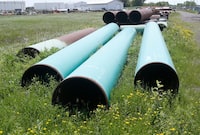 Pipeline used to carry crude oil sits at the Superior, Wis., terminal of Enbridge Energy, June 29, 2018. 