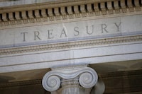 FILE- The U.S. Treasury Department building at dusk in Washington, June 6, 2019.  U.S. government officials on Wednesday started cracking down on the co-founders of the virtual currency mixer Tornado Cash, just days after a federal judge decided that the government had the authority to sanction them.  (AP Photo/Patrick Semansky, File)