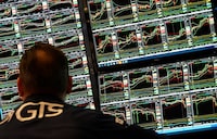 A trader works at his desk on the floor of the New York Stock Exchange (NYSE) during the first session of the new year on January 2, 2025, in New York City.