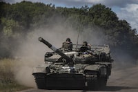 FILE Ñ A Ukrainian armored vehicle drives on the main road near the Russian border towards RussiaÕs Kursk region from UkraineÕs Sumy region, Aug. 12, 2024. One of the biggest unknowns for Ukraine is whether the Trump administration and Europe will provide any kind of security guarantees that would prevent Russia from trying to take more territory. (David Guttenfelder/The New York Times)