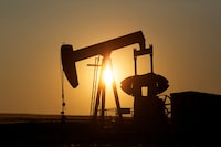 An oil pump jack pumps oil in a field near Calgary, Alberta, July 21, 2014