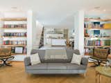 Open shelving between the living room and dining area maximizes light and air flow and showcases eclectic objects, which include old printing blocks found at a garage sale and bowls homeowner Kathryn Tyler’s mother bought in South Africa. For Tyler, storage is critical. "It's something that always gets overlooked but it's actually the most important thing. I calculated the linear footage of the books I own to make sure everything would fit."