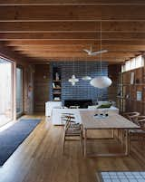 In the living room, spare Scandinavian design takes center stage. Hans Wegner’s Wishbone chairs surround an Essay dining table by Cecilie Manz for Fritz Hansen; a mostly wood palette is enhanced by slate-gray brick around the fireplace. The paper lanterns throughout the home are a mixture of classics by Isamu Noguchi alongside those picked up in Japan and France.