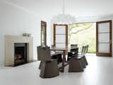 Konstantin Grcic’s Venus chairs for ClassiCon surround a table by Poliform in the formal dining room. Hill selected the Flos chandelier designed by Marcel Wanders for its "Old World reverence." The sleek fireplace mantel was designed by Hill and cobbled together onsite from three solid slabs of limestone.