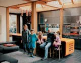 Taking inspiration from barns, warehouses, Case Study Houses, and Japanese residential architecture, architect Marcus Lee and his wife, Rachel Hart—an architectural model maker—created a unique timber-framed home in Hackney, London. In the kitchen, the Corian kitchen island unit acts as a real hub with a television tucked away under the worktop. However, the kids sit at the island for breakfast and other meals, and when guests come, they end up sitting there and talking while the owners are cooking.