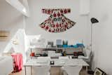 Above the 606 Universal shelving by Dieter Rams for Vitsœ, Molineus displays a Central Asian ikat wedding garment that dates to around 1900. The Gaku floor lamp at left is by Dagmar Mombach and Ingo Maurer.