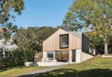 An architect reimagines an outdated brick garage by designing a graceful new family home atop its foundation.