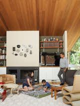 As his parents look on, Apolo plans his commute under a fire-top piece by the artist Michael Ricardo Andreev and alongside a Wiggle chair by Frank Gehry.