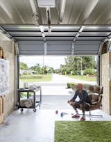 Christopher, known professionally as Flore,  surveys a painting in his garage turned studio.